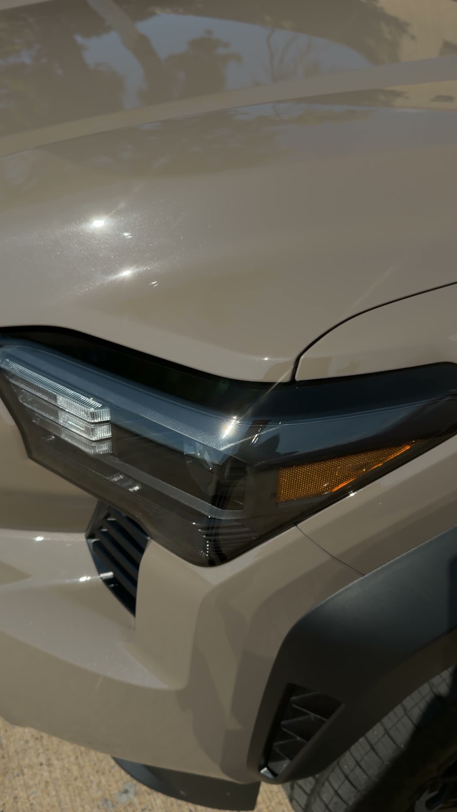 Smoked headlight protection film on a Toyota Tacoma TRD