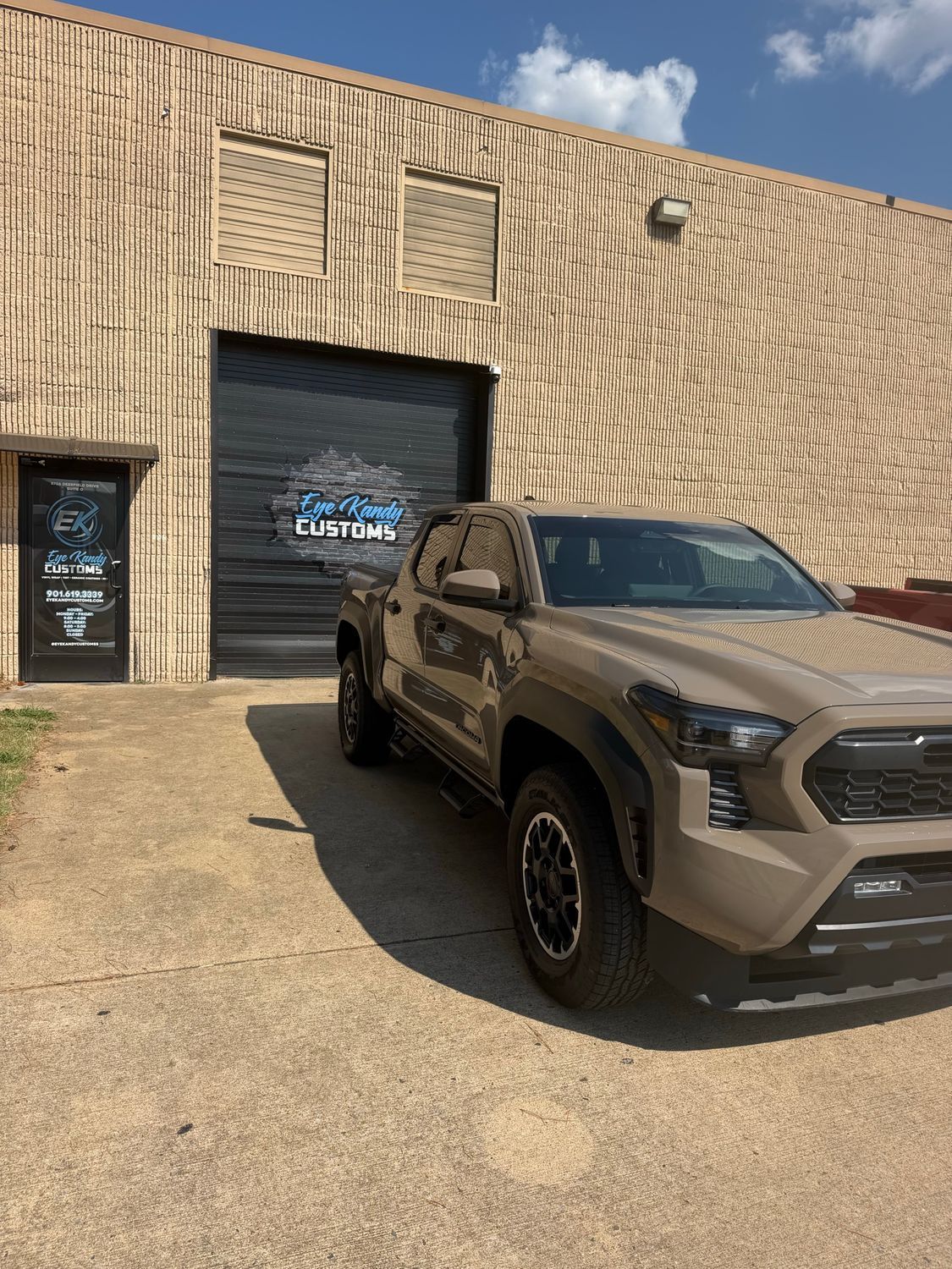 Side profile of the Tacoma TRD at the Eye Kandy Customs shop entrance