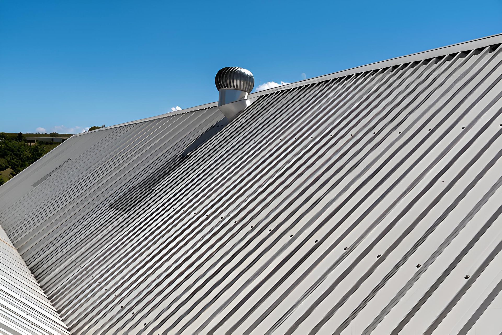 A Close Up of a Metal Roof With a Chimney on Top of It — Ron Nickel Roofing in Banora Point, NSW
