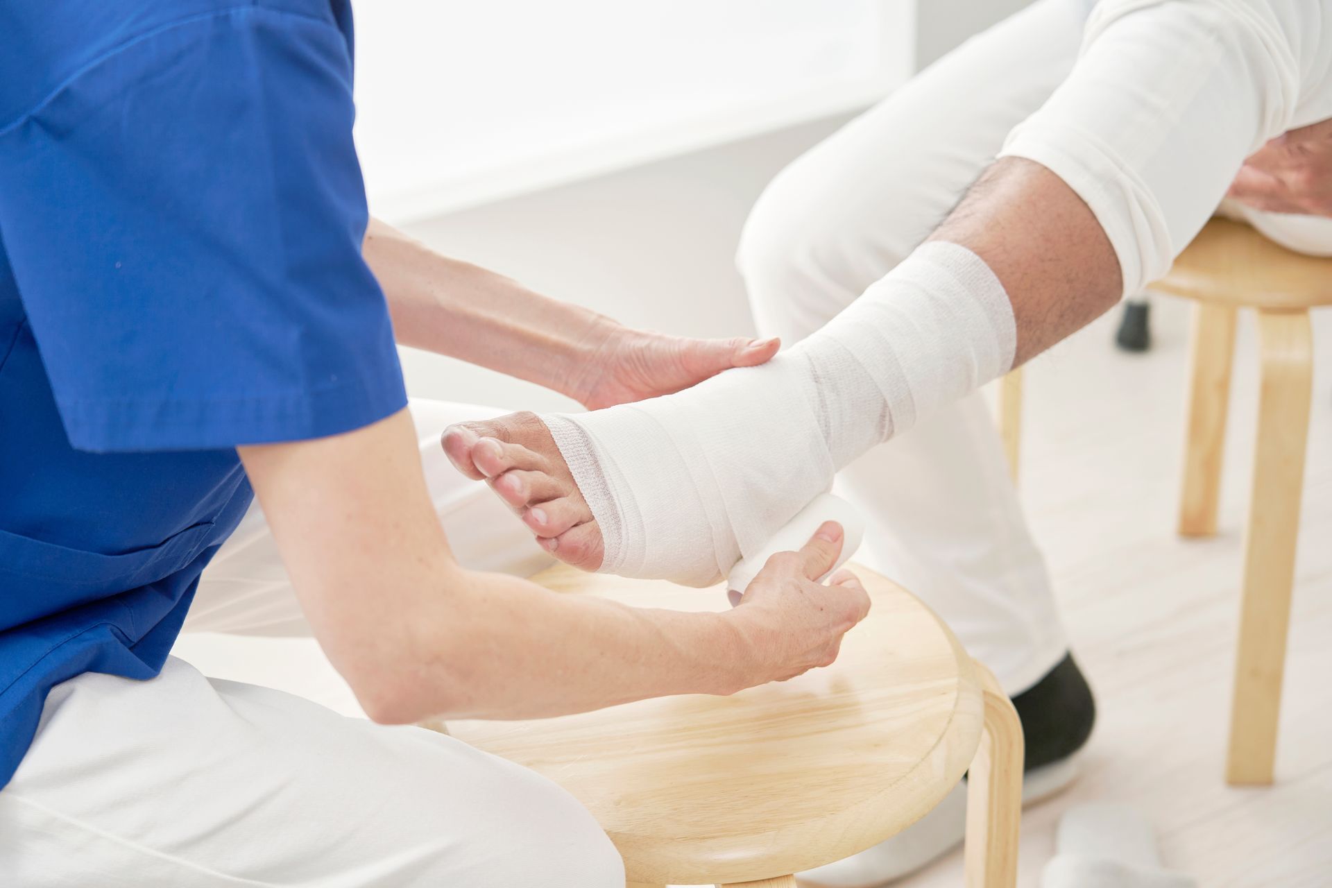 A person with a cast on their foot is being examined by a doctor.