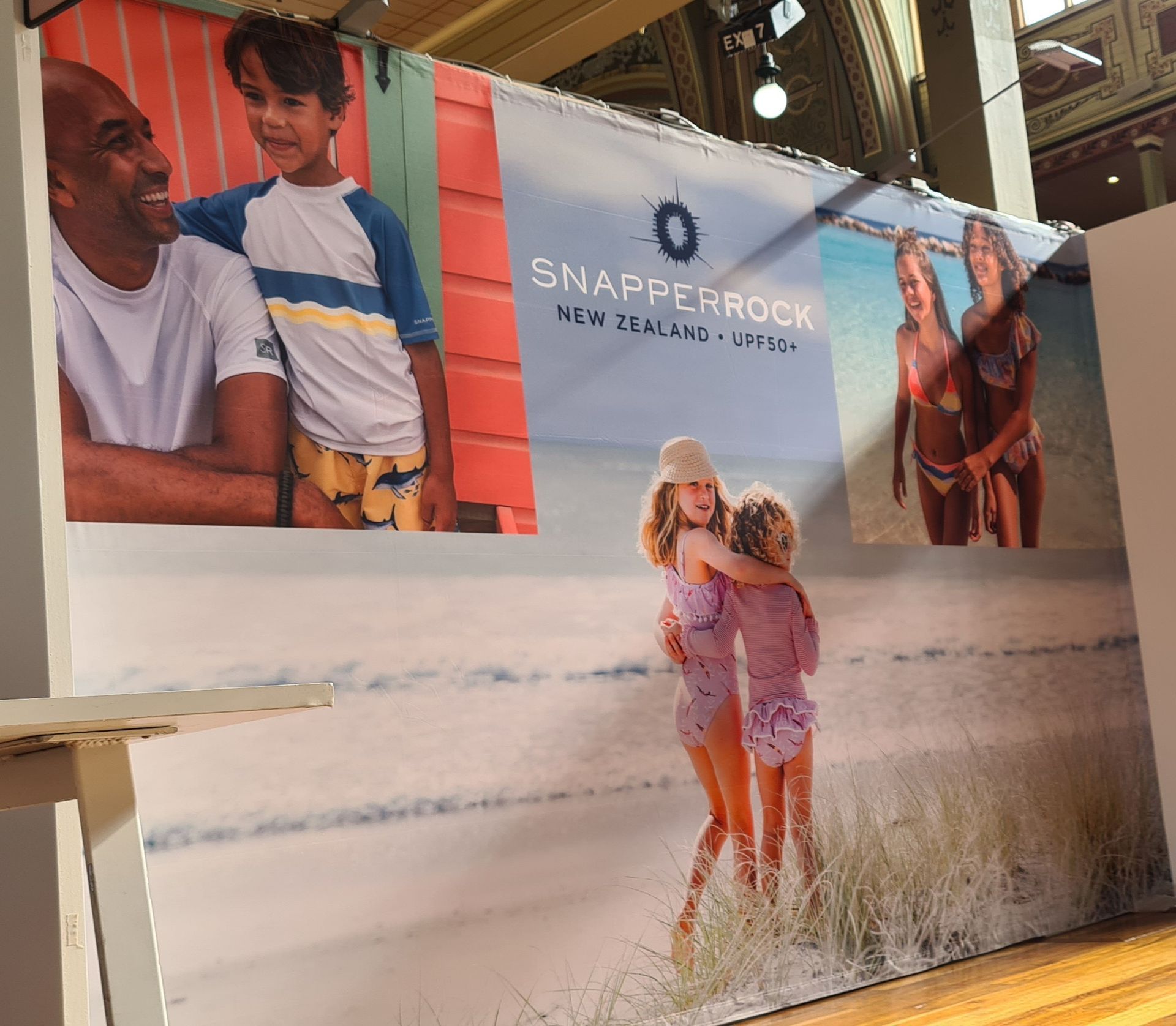 A wall with a picture of a man and two children on it