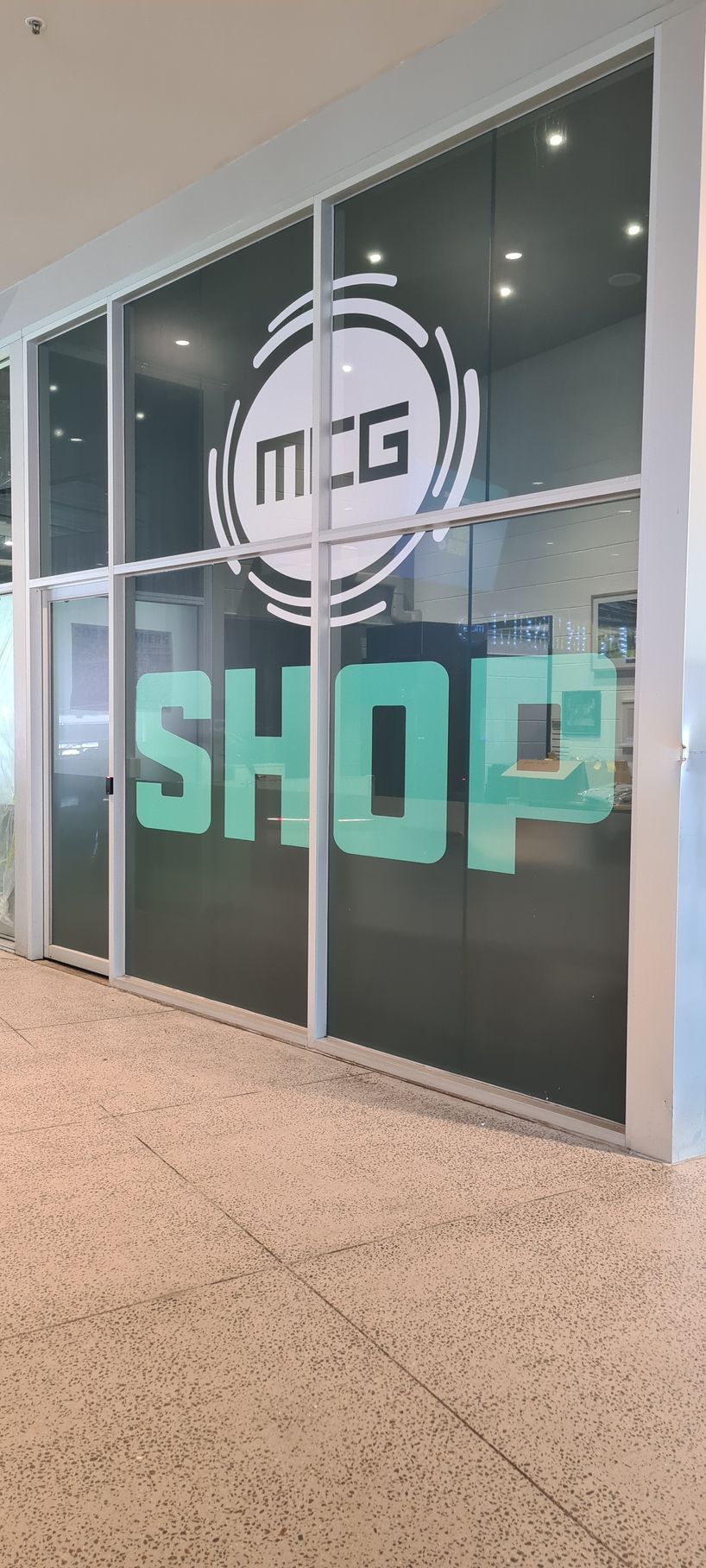 A store front with a sign on the window that says `` shop ''.