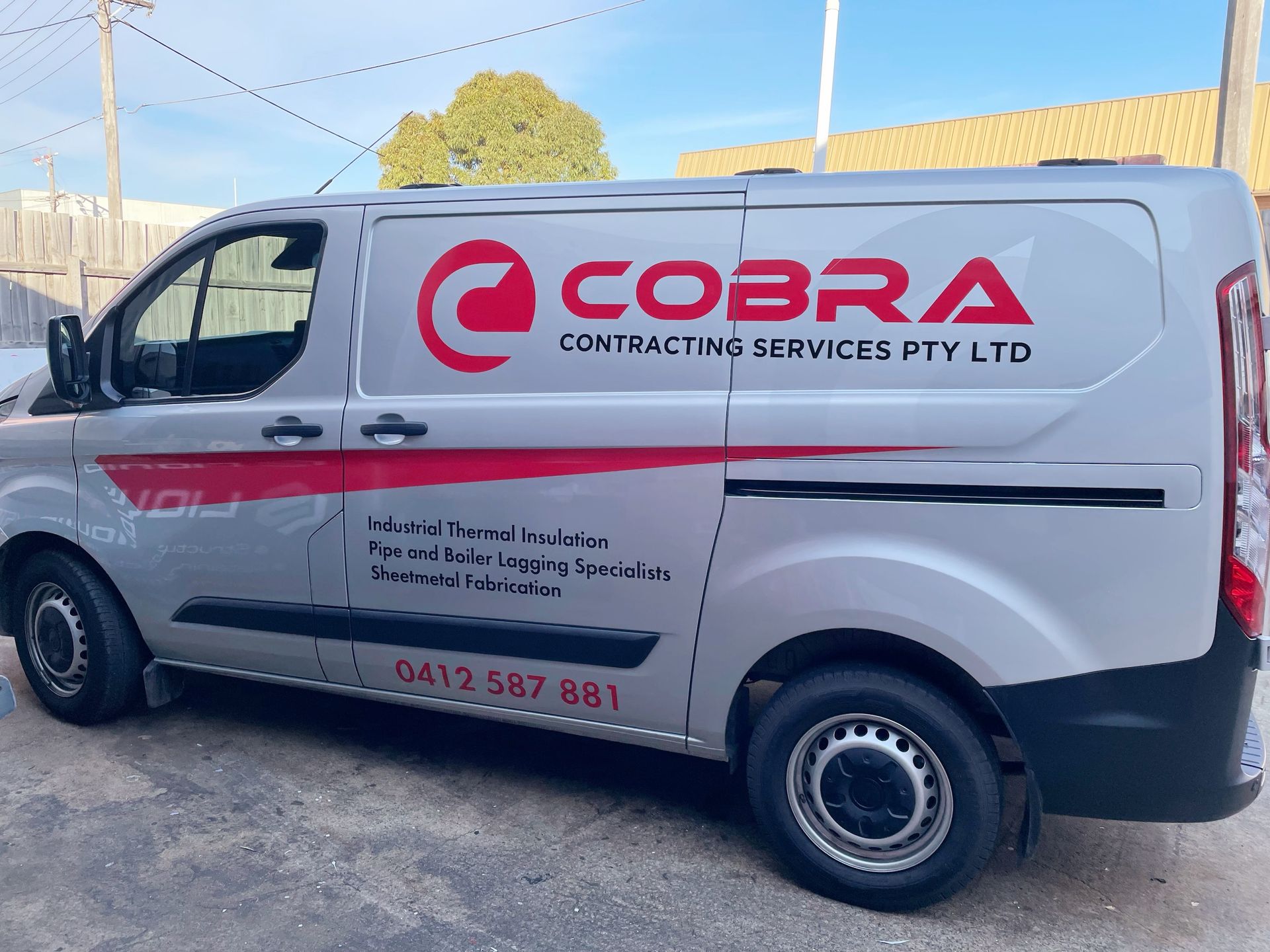 A silver van with the word cobra on it