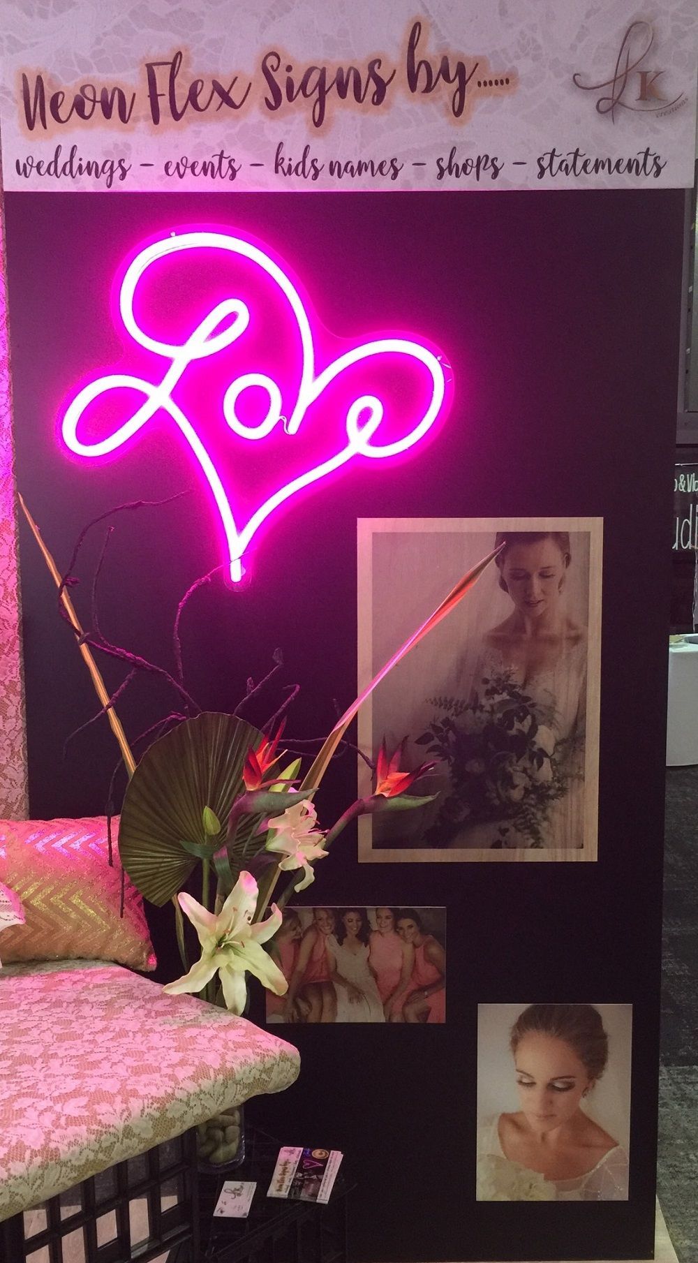 A neon sign that says love is hanging on a wall.