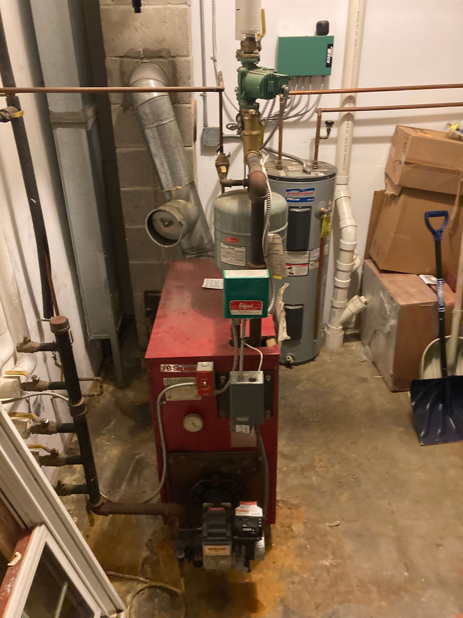 A professional residential boiler system in a home basement utility room.