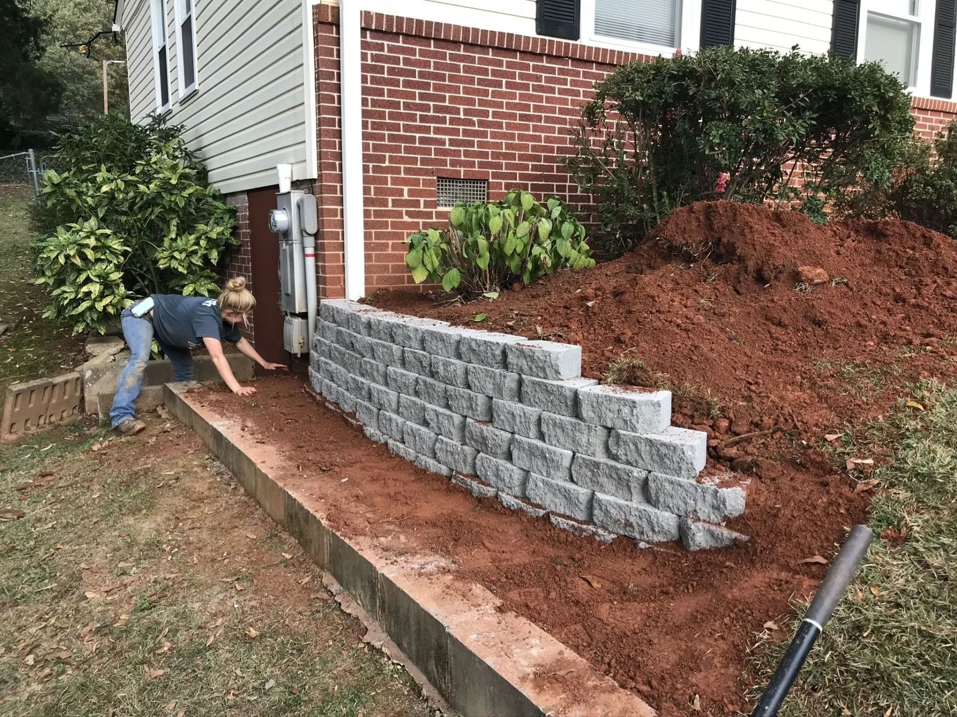 Grey stone retaining wall in a garden bed