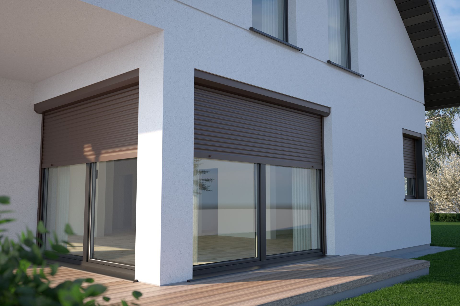 Modern white house exterior with large glass doors, brown shutters, and a wooden patio under bright sunlight