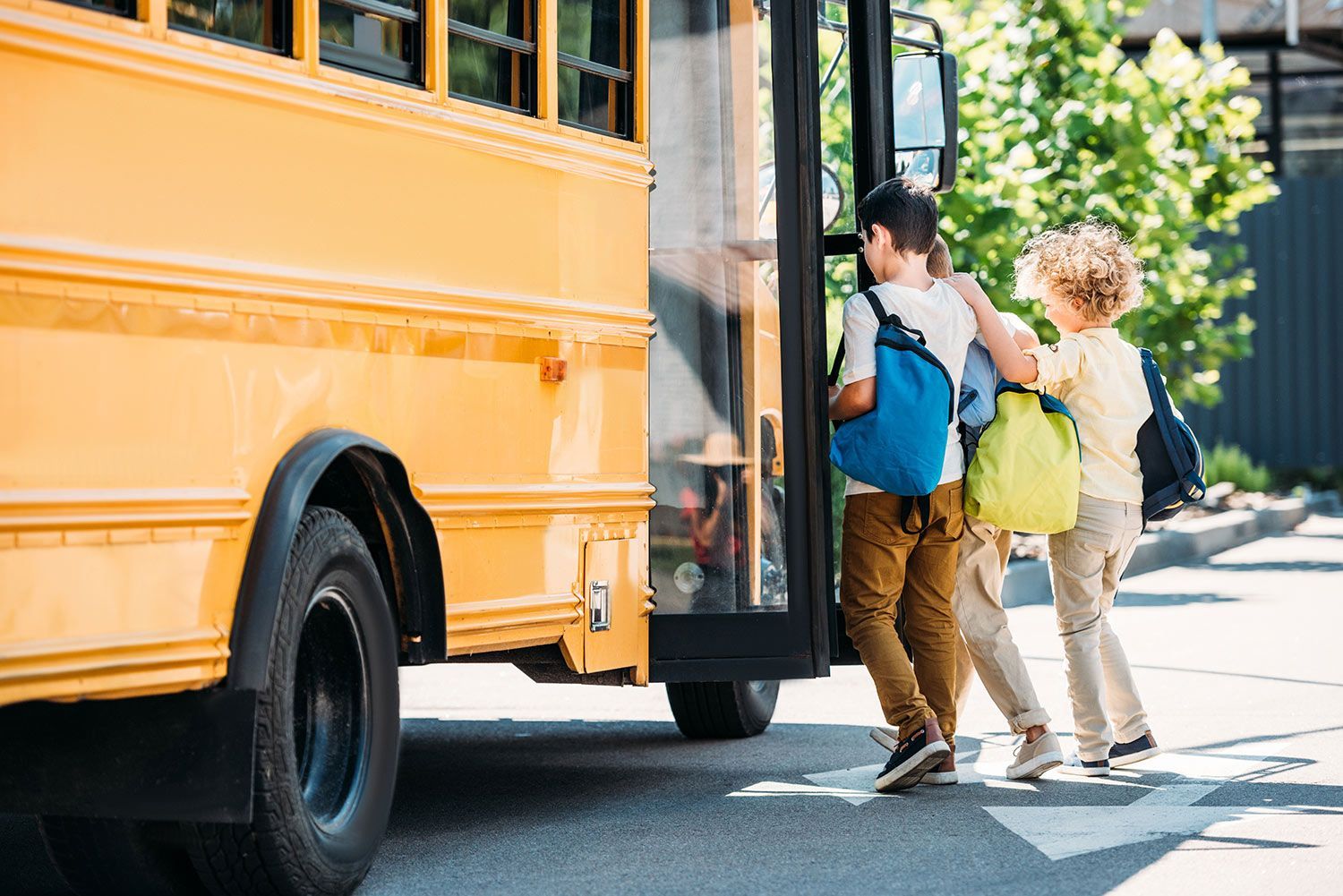 Children entering in a yellow school bus