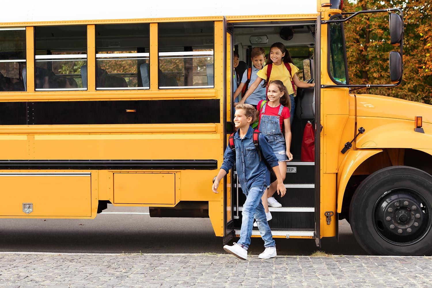 Children exiting a yellow school bus