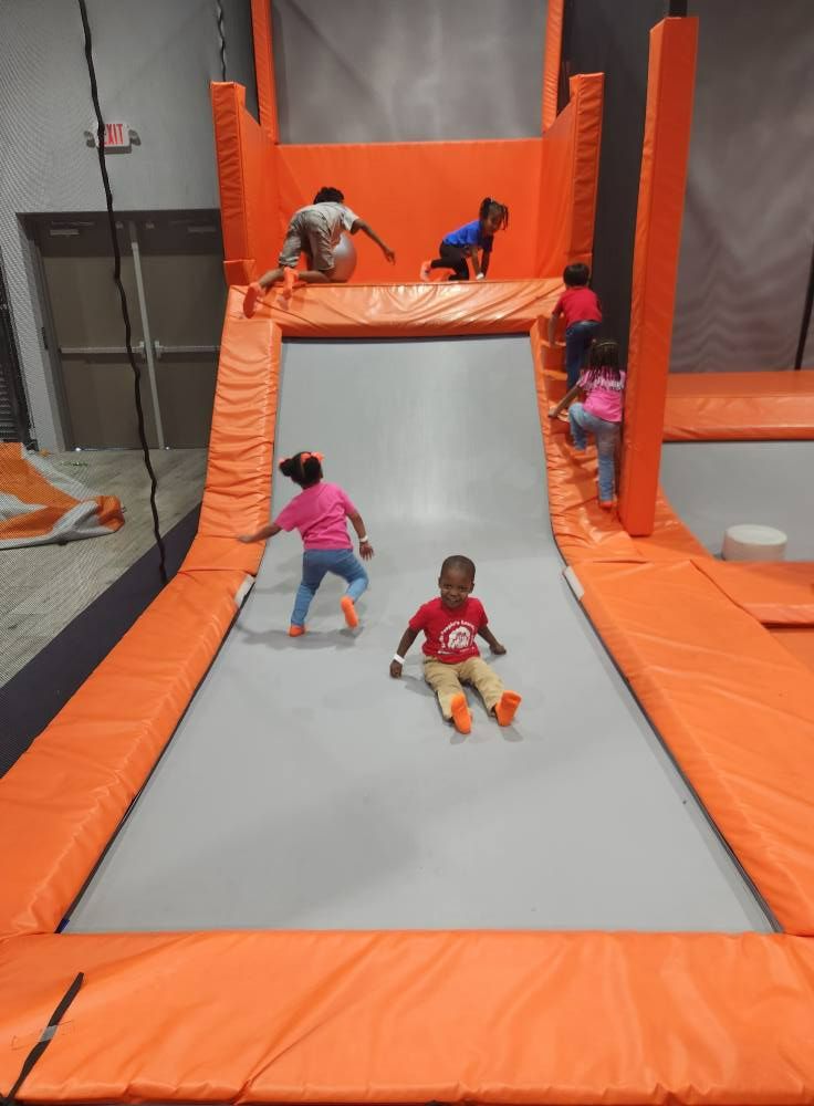 Children playing on indoor inflatable obstacle course