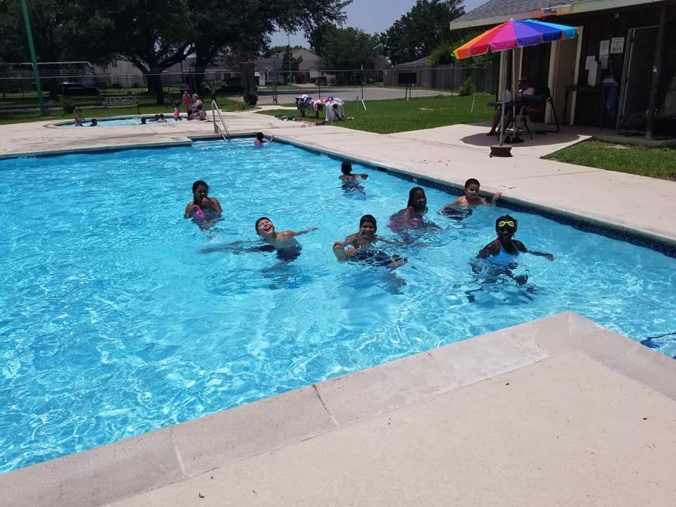 Children swimming in an outdoor pool