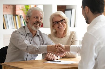 Elder Couple Shaking Hands With Lawyer — Pahrump, NV — Roland Law Firm Elder Couple Shaking Hands With Lawyer — Pahrump, NV — Roland Law Firm