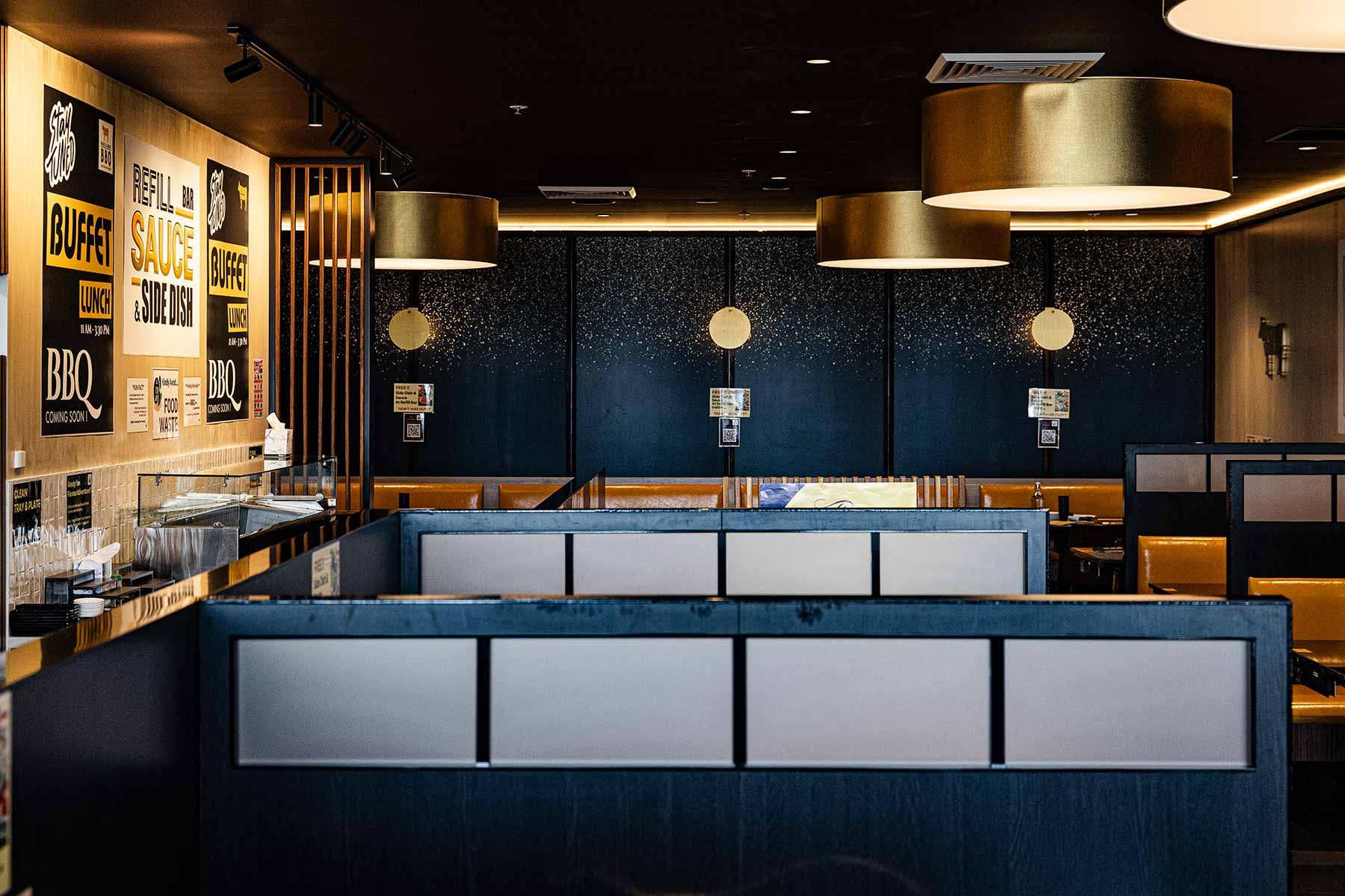 Modern Restaurant Interior With Golden Hanging Lamps and Wall Signs — JMB Electrical Services In Port Kembla, NSW