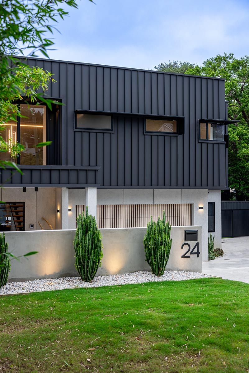 House With Sleek Black Metal Siding and Narrow Windows — JMB Electrical Services In Port Kembla, NSW