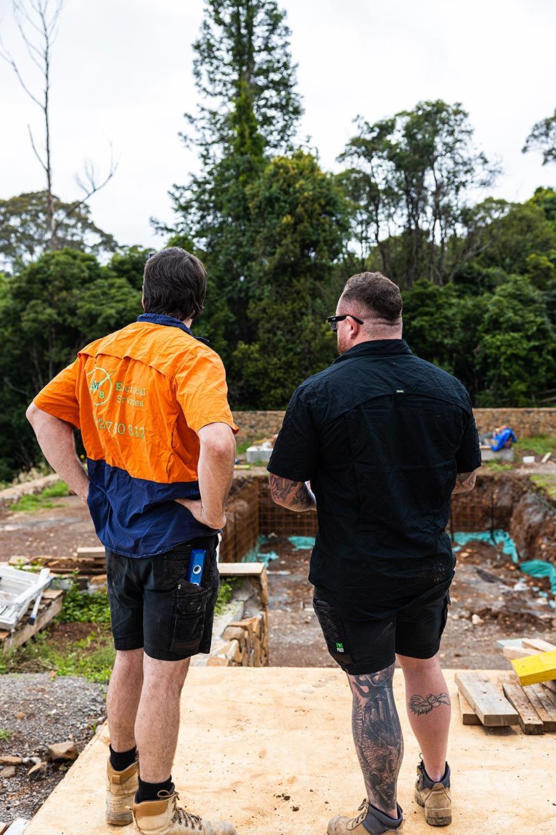 Two Men Overlooking a Construction Site Surrounded by Trees — JMB Electrical Services In Port Kembla, NSW