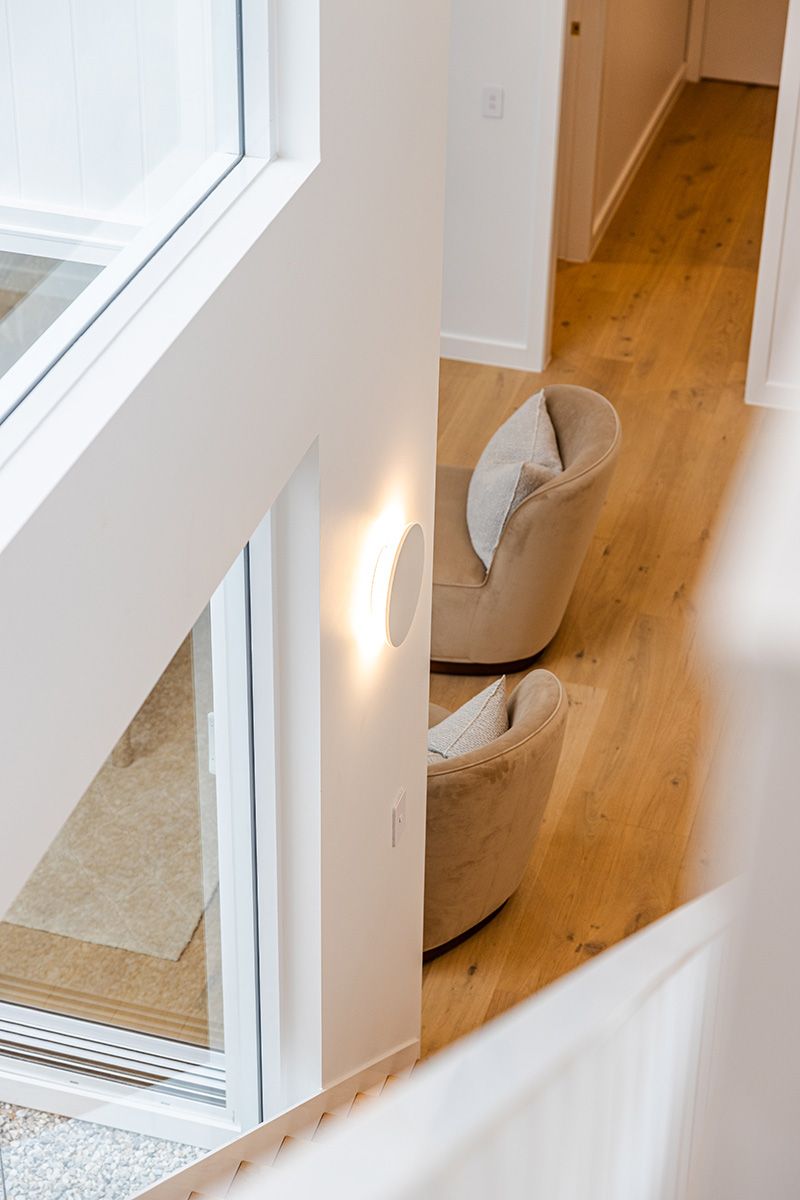 Two Beige Armchairs With Cushions on Wood Floor — JMB Electrical Services In Port Kembla, NSW