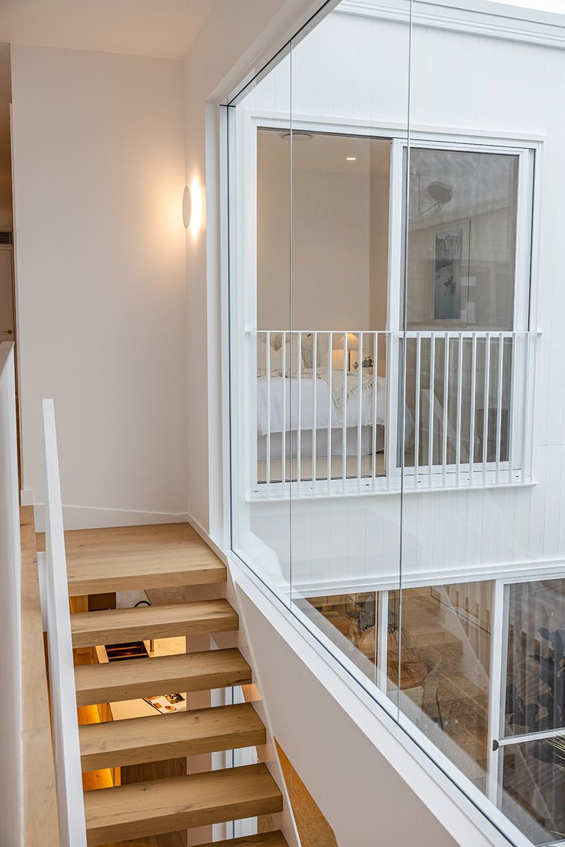 A Wooden Staircase With White Railing — JMB Electrical Services In Port Kembla, NSW