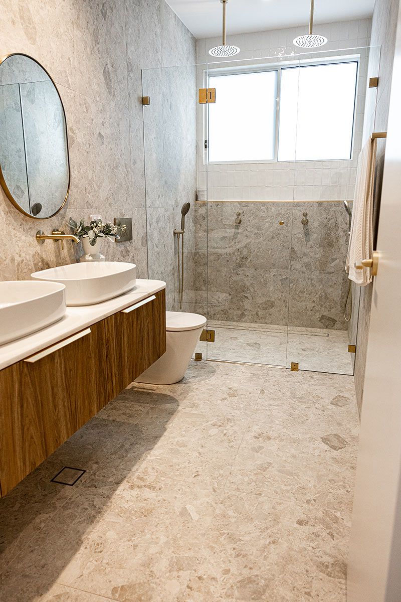 Bathroom With Marble Tiles and Glass Shower — JMB Electrical Services In Port Kembla, NSW