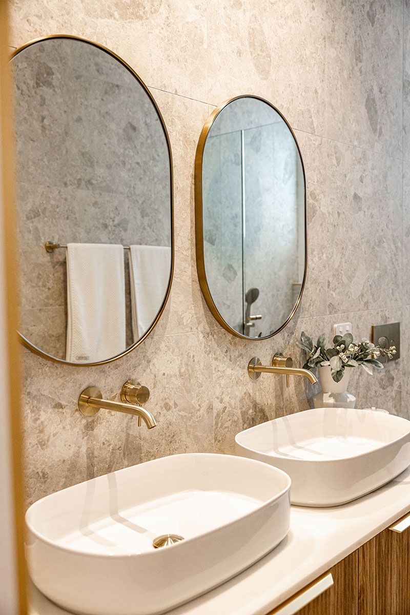 Bathroom With Dual Oval Mirrors Above Sinks — JMB Electrical Services In Port Kembla, NSW