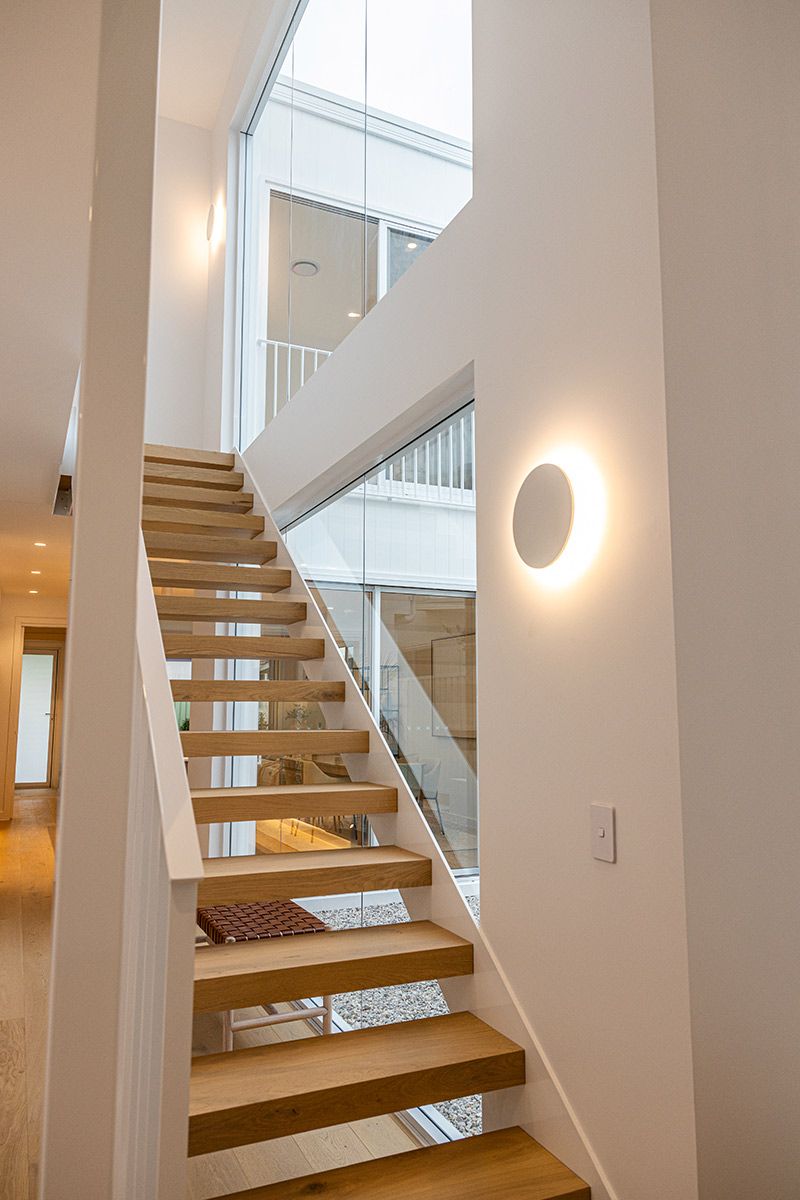 Wooden Staircase With Open Risers and Glass Walls — JMB Electrical Services In Port Kembla, NSW