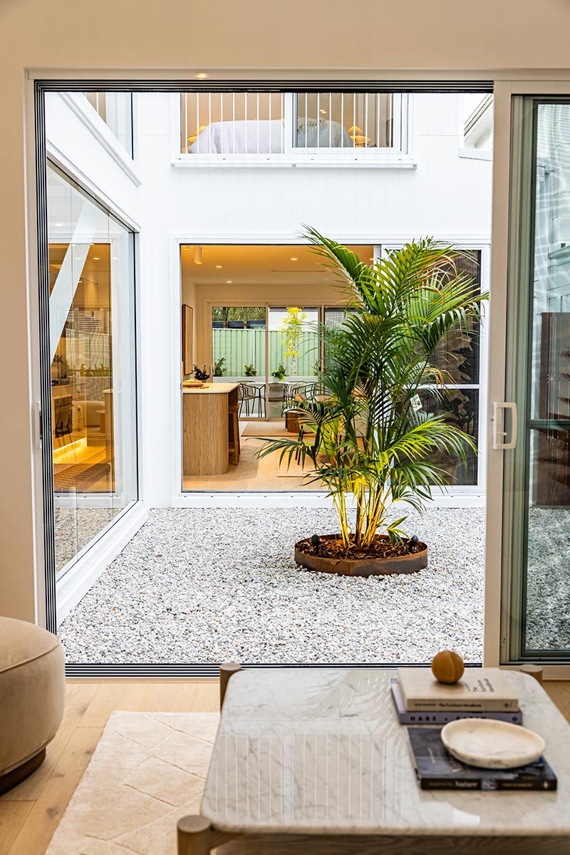 A Courtyard With a Palm Tree in the Middle — JMB Electrical Services In Port Kembla, NSW