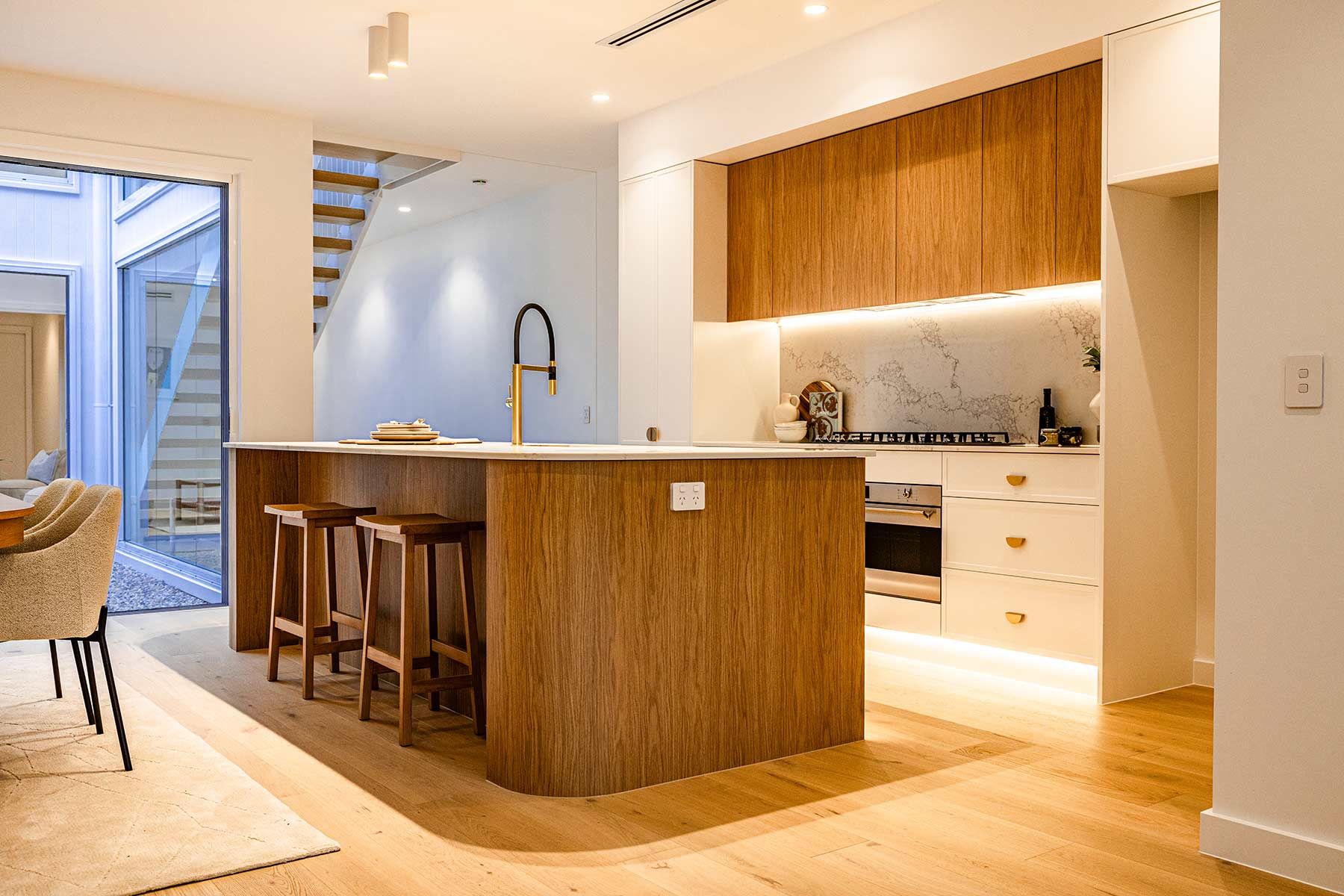 A Kitchen With Stools and a Large Island — JMB Electrical Services In Port Kembla, NSW