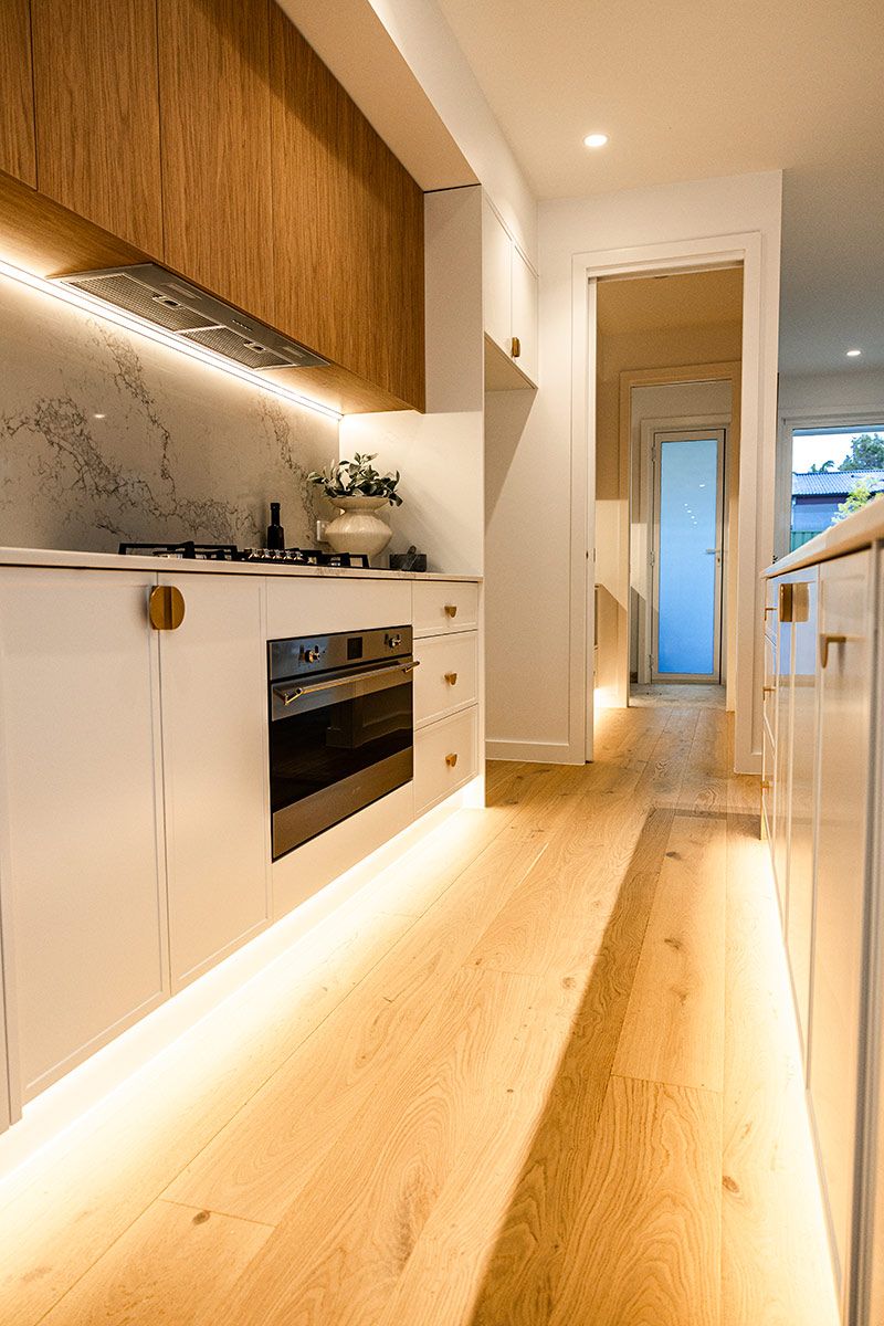A Kitchen With White Cabinets and a Stove — JMB Electrical Services In Port Kembla, NSW