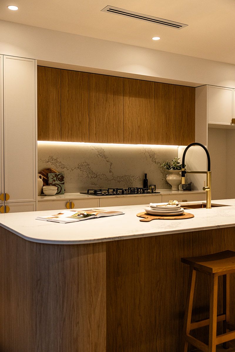 A Kitchen With Wooden Cabinets and a White Counter Top — JMB Electrical Services In Port Kembla, NSW