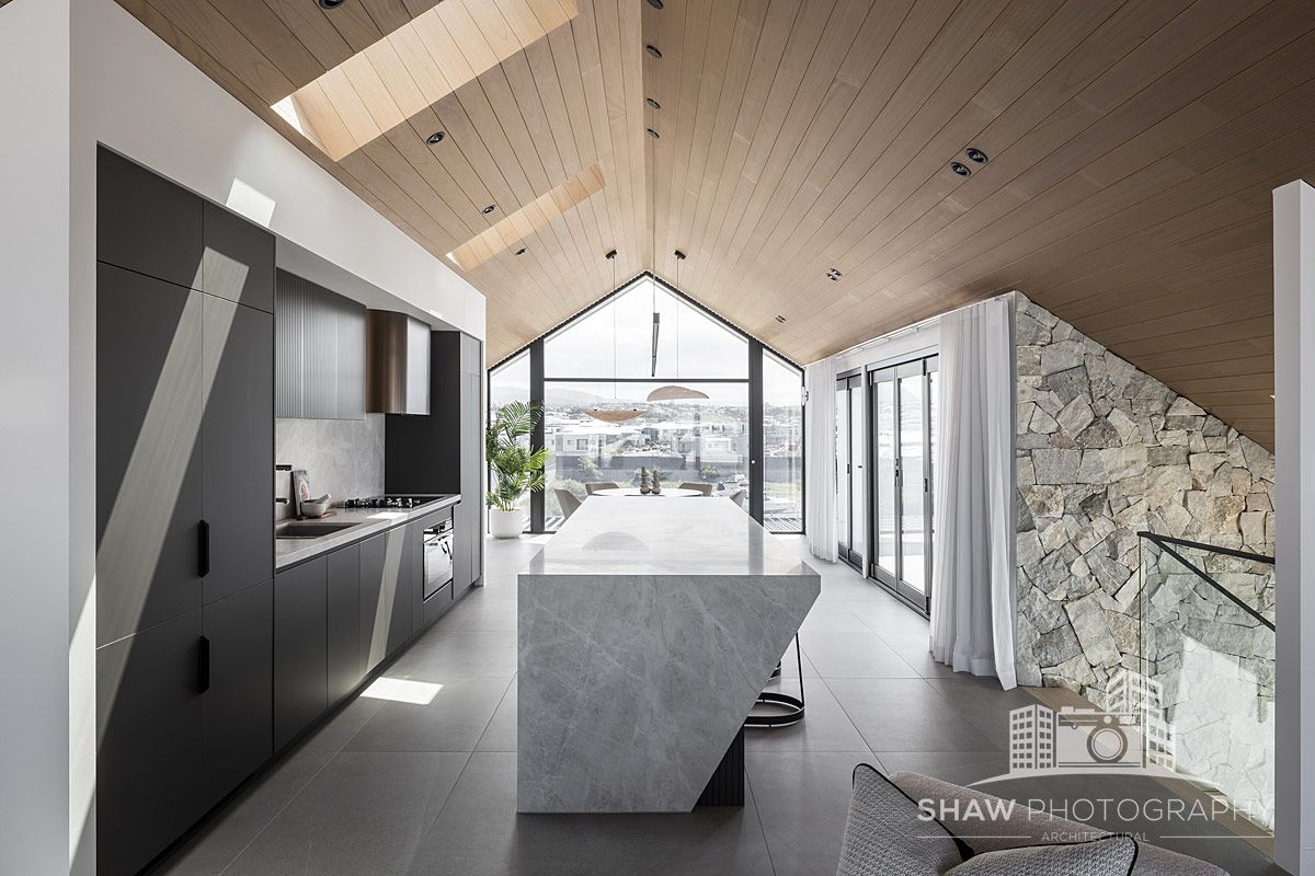 Kitchen With a Sloped Wooden Ceiling and Large Windows — JMB Electrical Services In Port Kembla, NSW