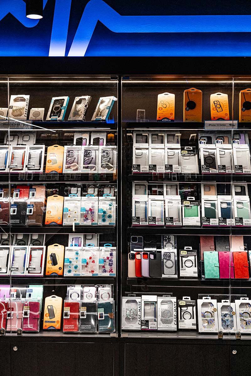 Various Smartphone Cases in a Store, Arranged Neatly on Shelves — JMB Electrical Services In Port Kembla, NSW