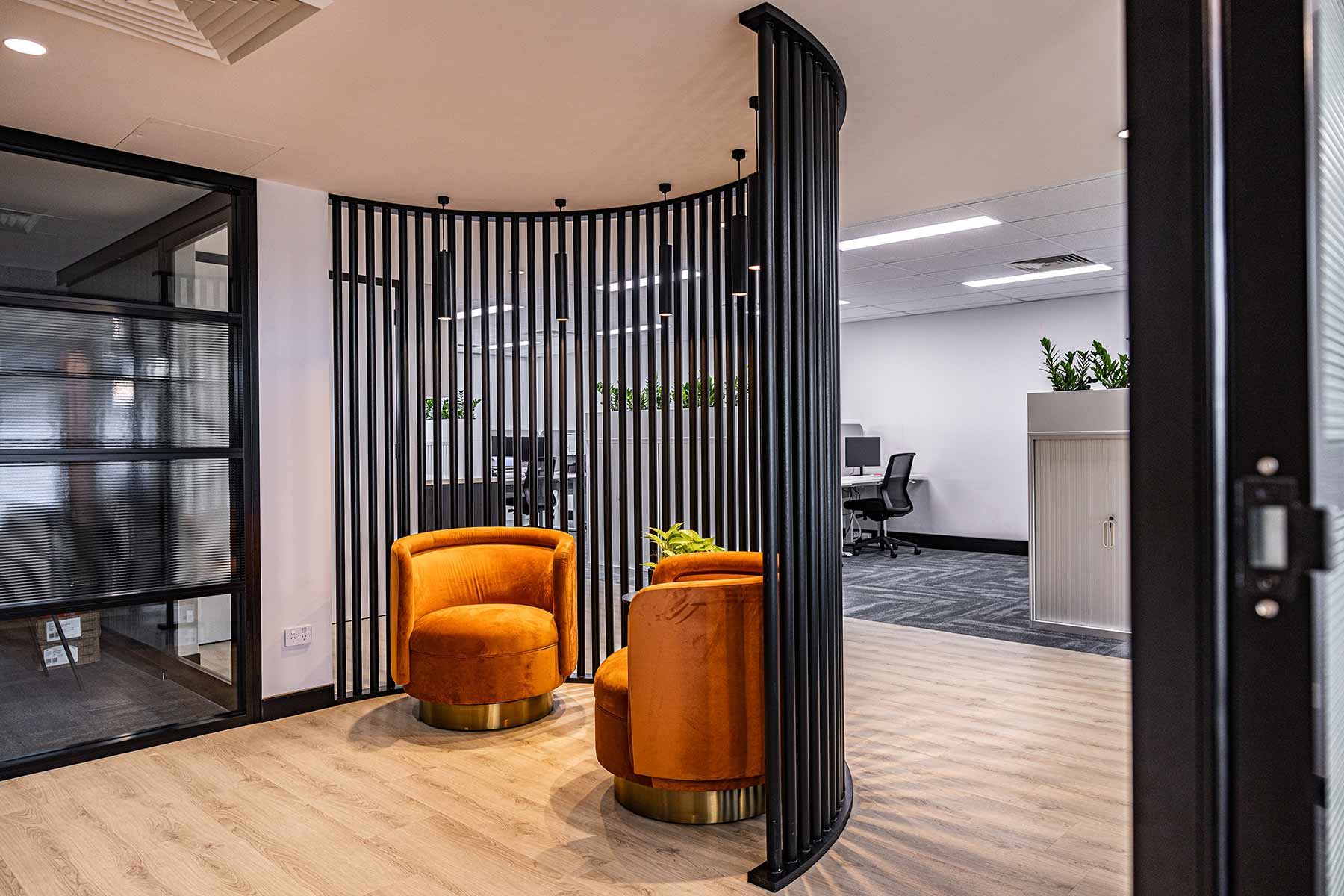 Office Space With Two Vibrant Orange Chairs — JMB Electrical Services In Port Kembla, NSW