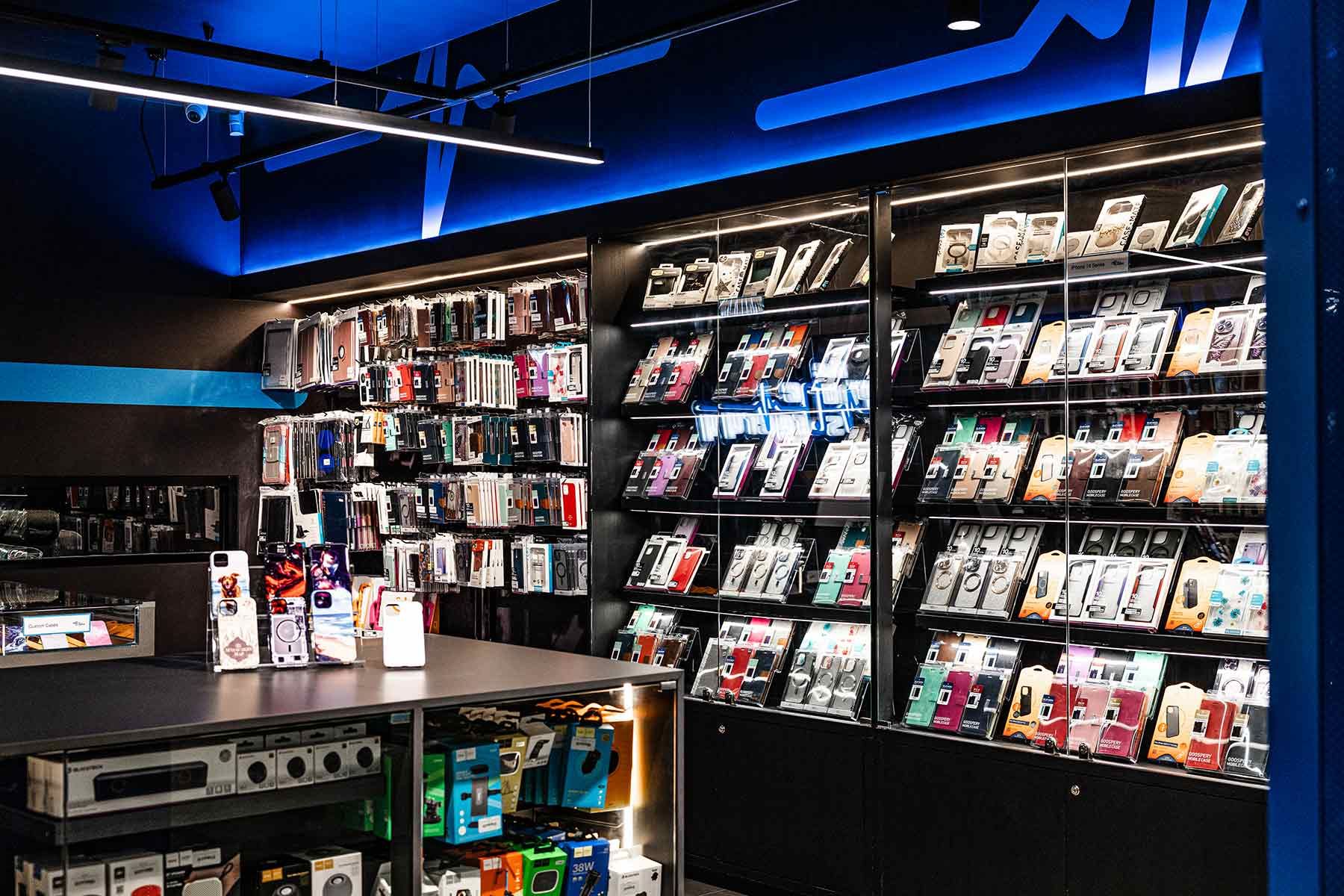 A Store Displays Multiple Smartphone Cases on Shelves — JMB Electrical Services In Port Kembla, NSW