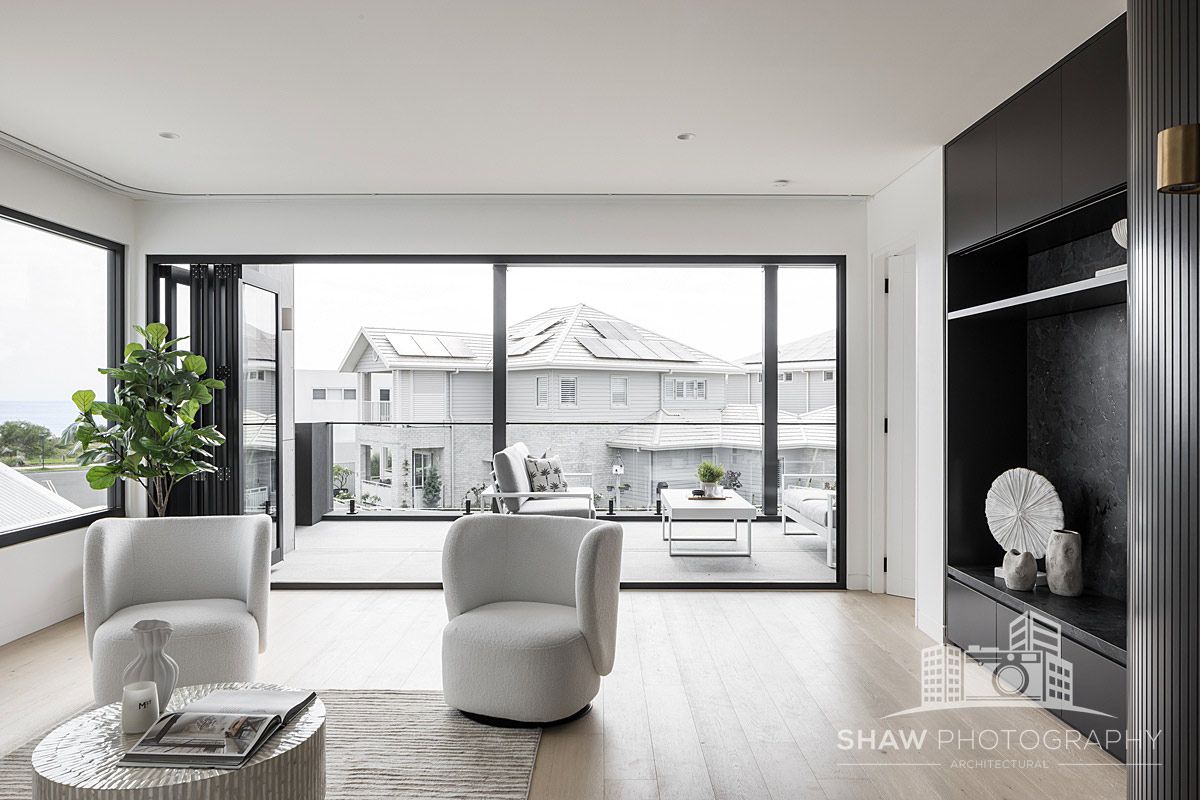 A Living Room With Two Chairs and a Large Window — JMB Electrical Services In Port Kembla, NSW