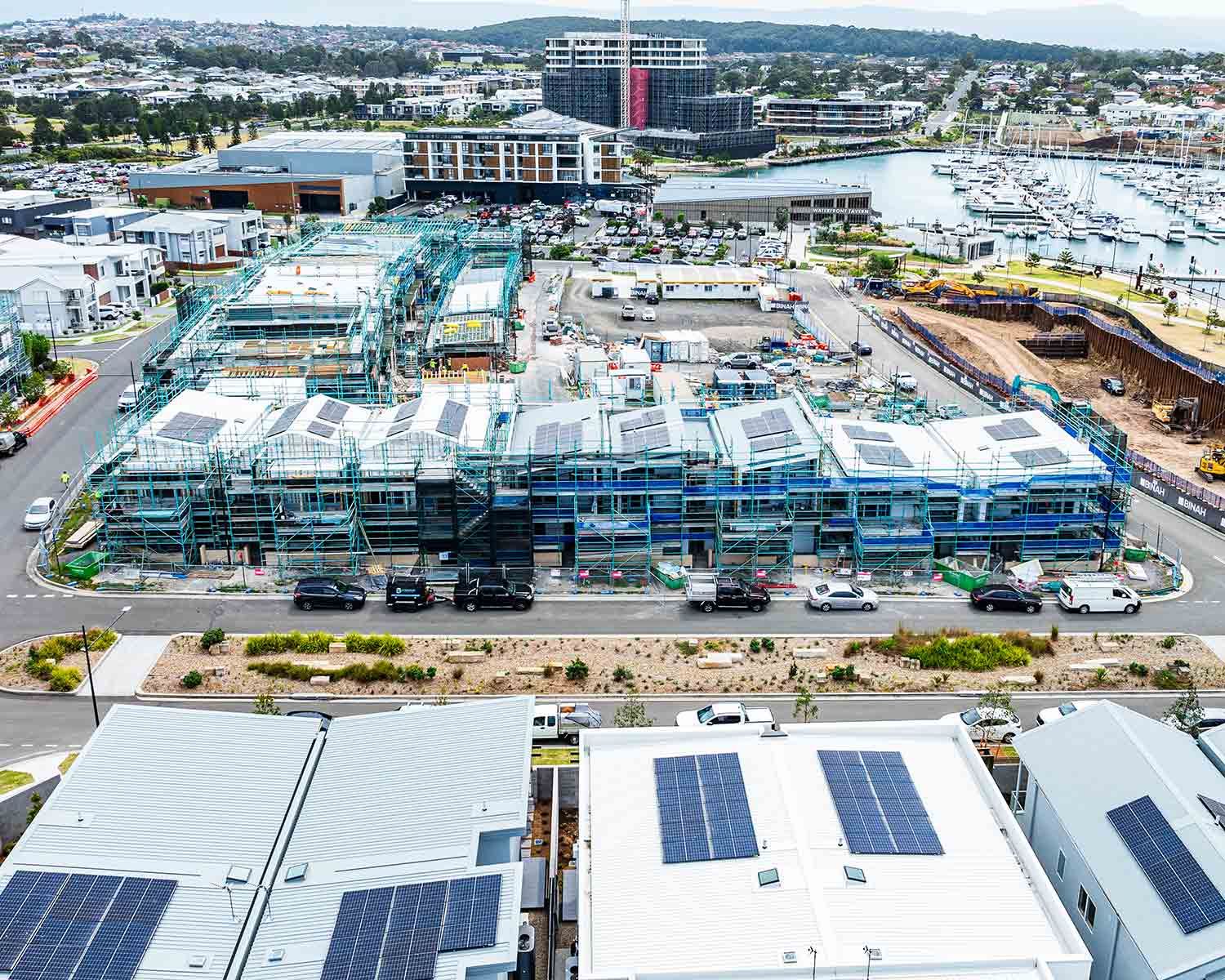Buildings Covered in Scaffolding and Solar Panels — JMB Electrical Services In Port Kembla, NSW