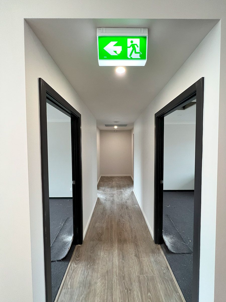 Hallway With Light Wood Flooring and Two Open Doorways — JMB Electrical Services In Port Kembla, NSW
