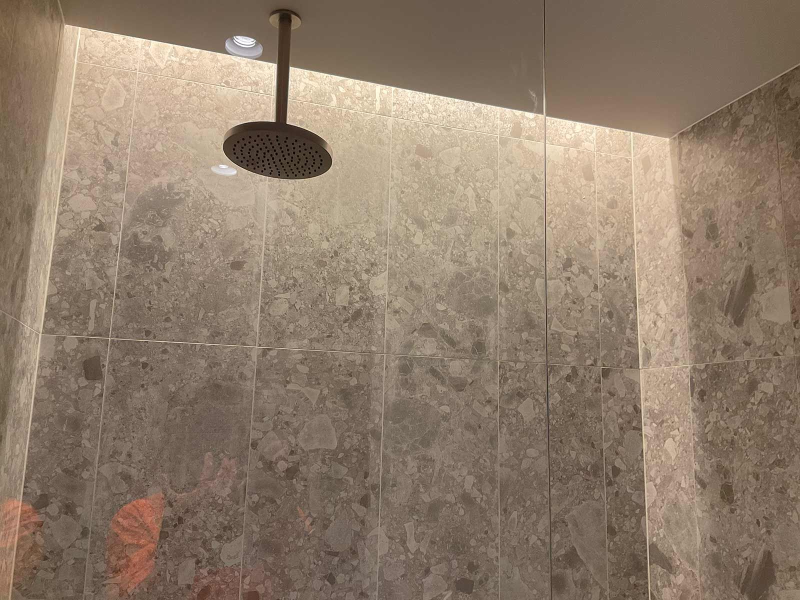 Modern Shower Interior With Textured Grey Stone — JMB Electrical Services In Port Kembla, NSW