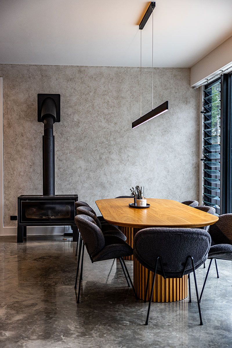 Dining Room With a Wooden Table Surrounded by Grey Chairs — JMB Electrical Services In Port Kembla, NSW