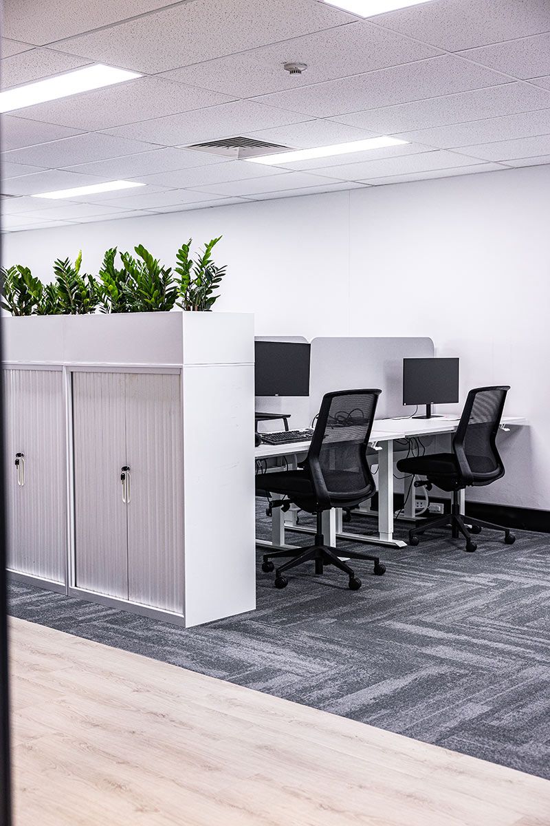 Office Space With Two Chairs and Computer Monitors — JMB Electrical Services In Port Kembla, NSW