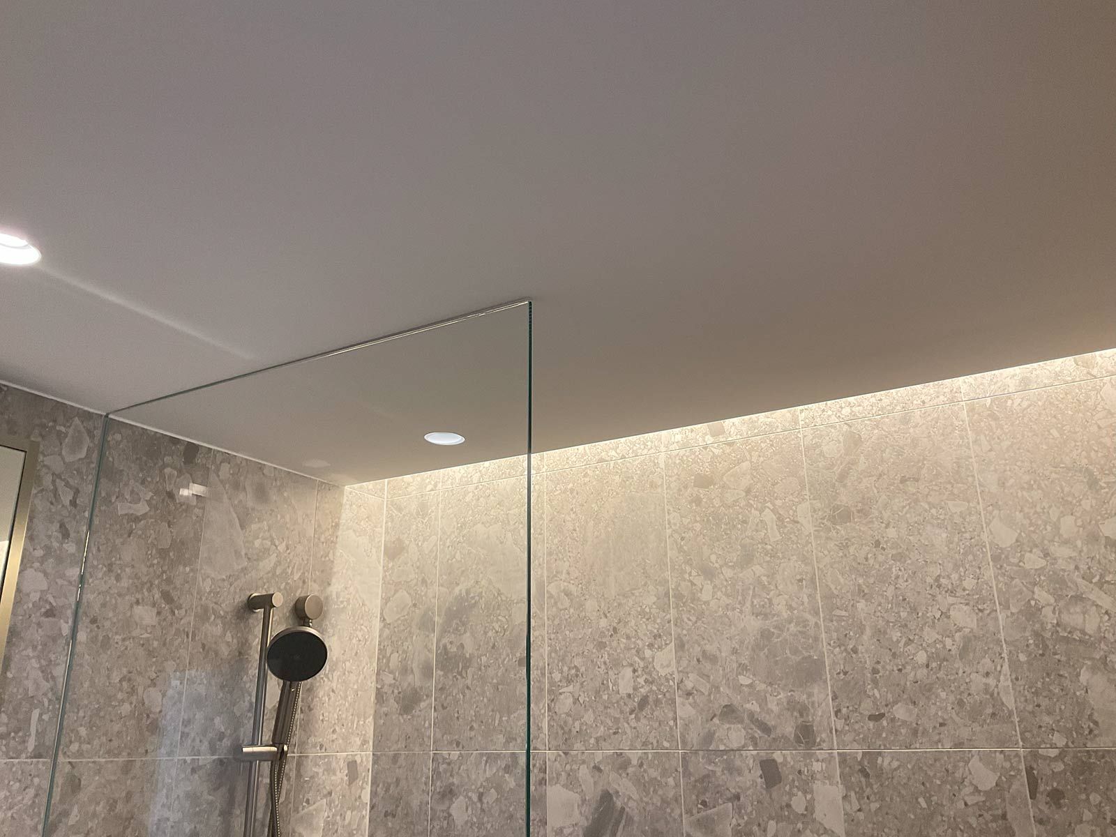 A Bathroom With a Walk in Shower and a Ceiling Light — JMB Electrical Services In Port Kembla, NSW