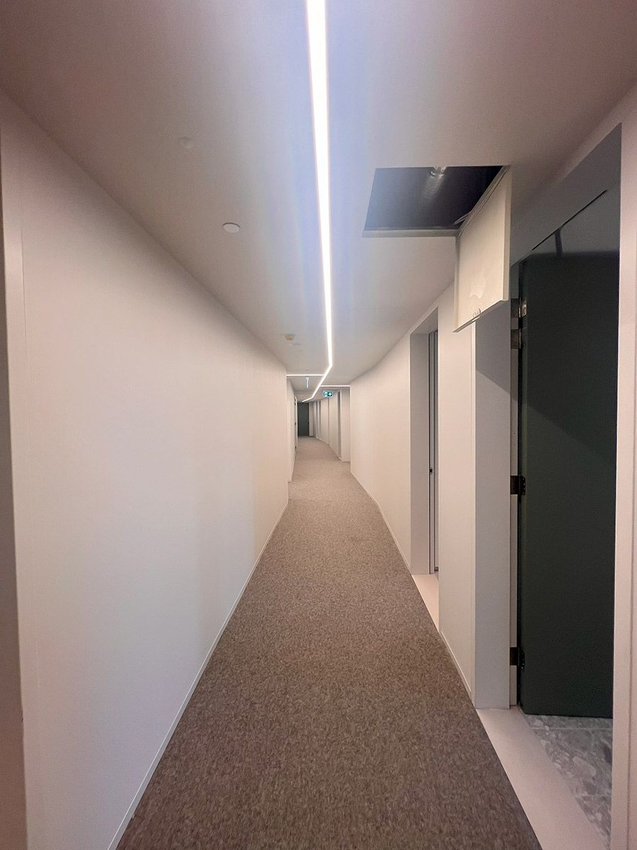 Empty Corridor With Beige Carpet and White Walls — JMB Electrical Services In Port Kembla, NSW