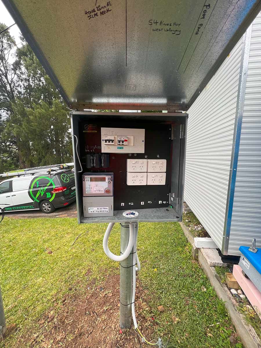 An Open Electrical Box With Circuit Breakers and Power Outlets — JMB Electrical Services In Port Kembla, NSW