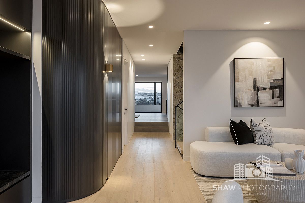 A Living Room With a Couch and a Painting on the Wall — JMB Electrical Services In Port Kembla, NSW