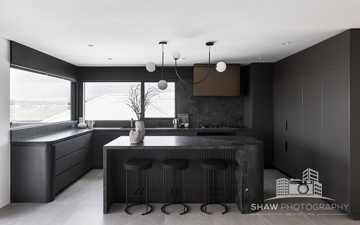 A Kitchen With Black Cabinets and a Large Island — JMB Electrical Services In Port Kembla, NSW