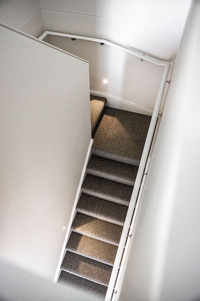 A Carpeted Staircase and a White Railing — JMB Electrical Services In Port Kembla, NSW