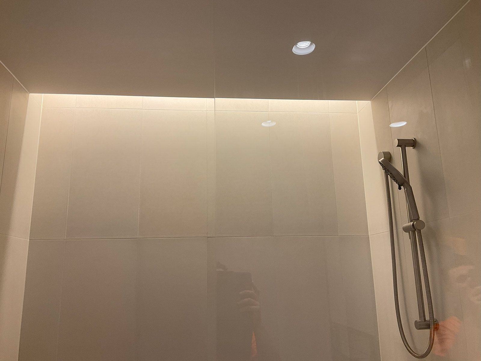 Minimalist Shower Interior With Beige Tiled Walls — JMB Electrical Services In Port Kembla, NSW
