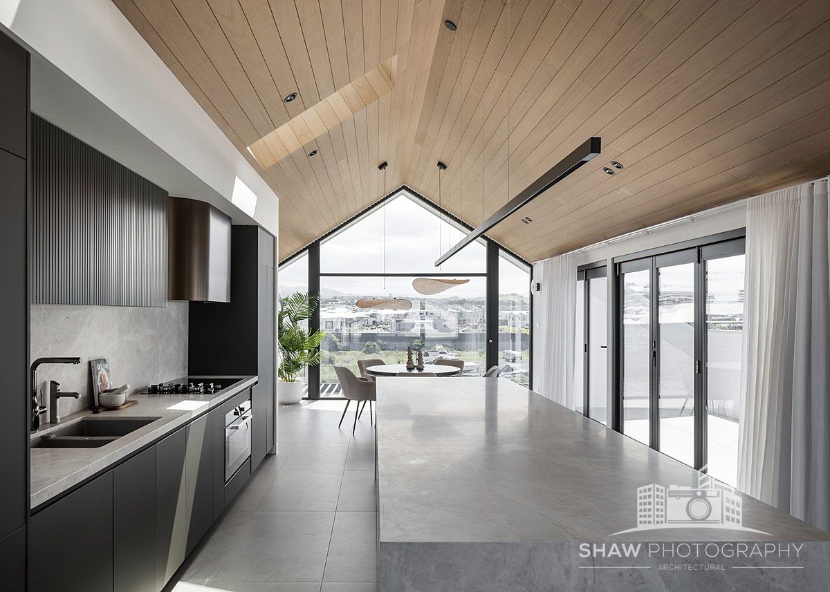 A Kitchen With a Vaulted Ceiling and a Large Island — JMB Electrical Services In Port Kembla, NSW