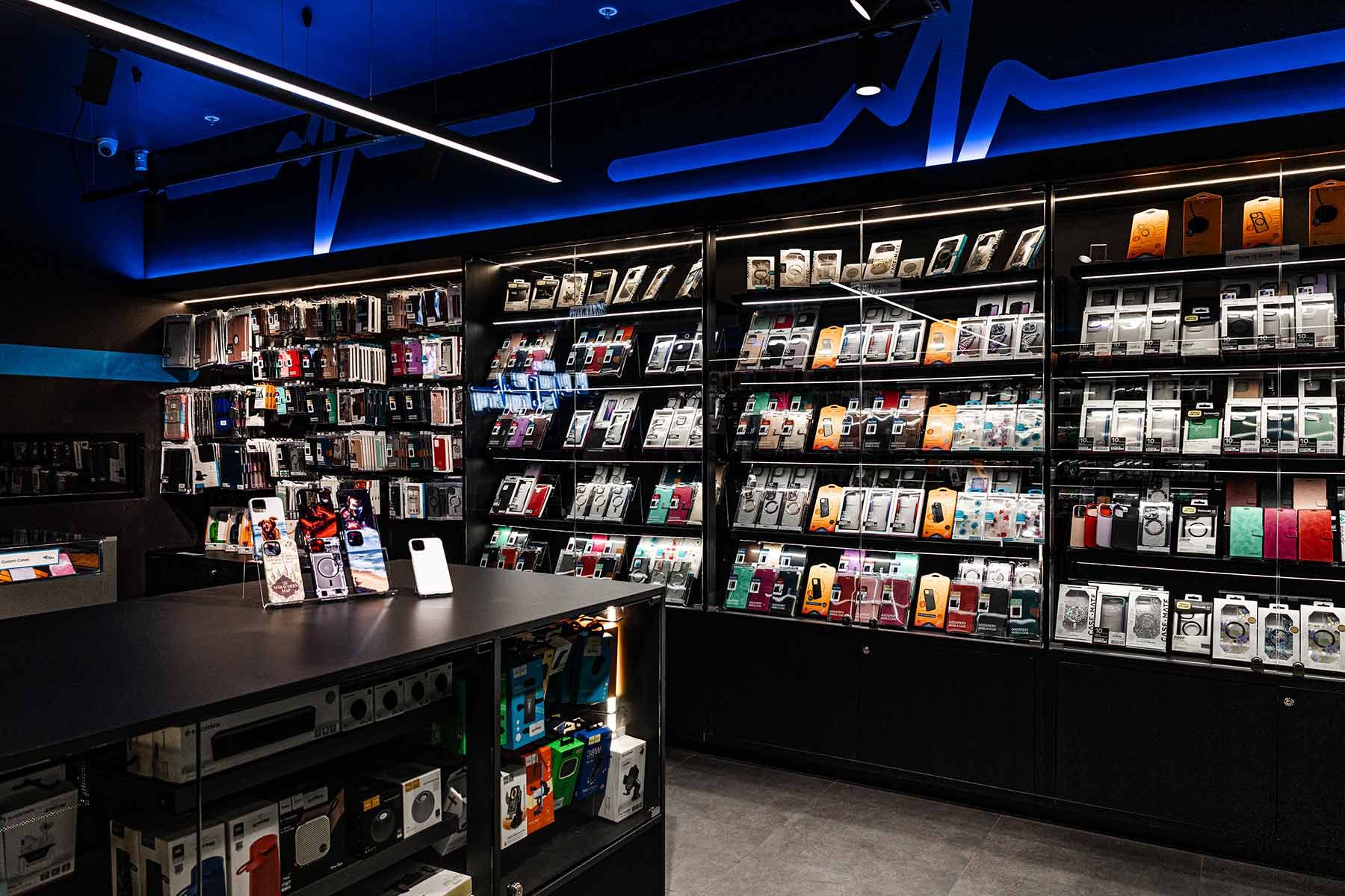 Electronics Store Interior With Shelves Displaying Various Phone Cases — JMB Electrical Services In Port Kembla, NSW