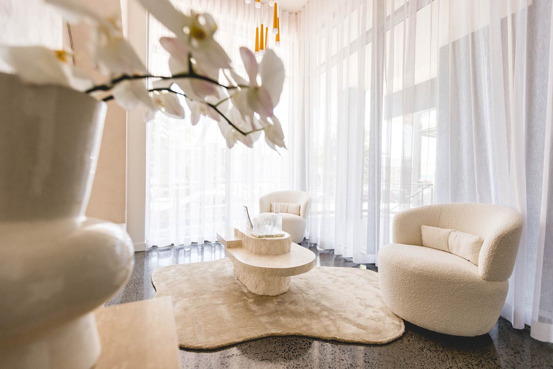 A Living Room Featuring Two Plush Cream Chairs — JMB Electrical Services In Port Kembla, NSW