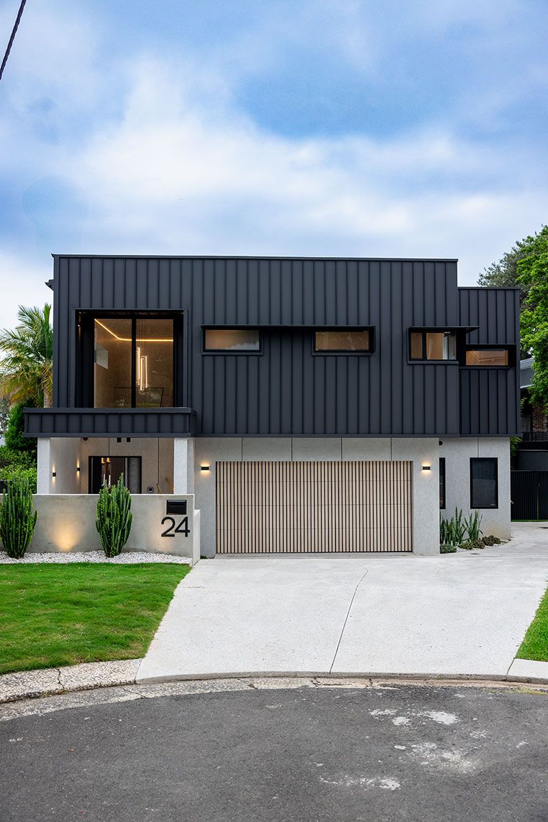 House With Large Windows and a Wooden Garage Door — JMB Electrical Services In Port Kembla, NSW
