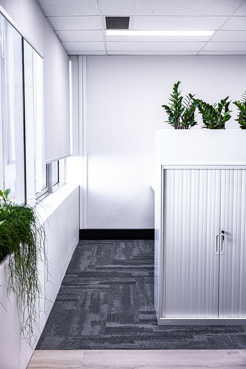 Office Corner With Gray Carpet and White Walls — JMB Electrical Services In Port Kembla, NSW